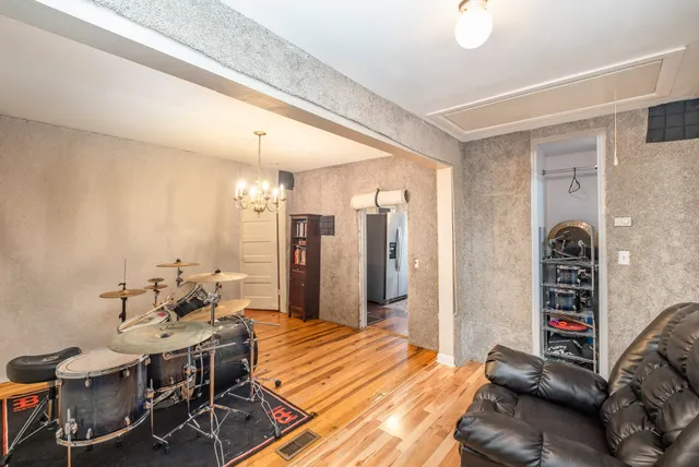 a bedroom with furniture and a wooden floor