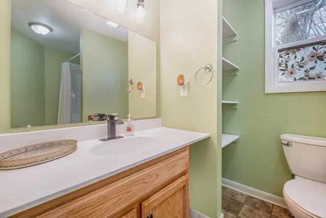 a bathroom with a sink a toilet and mirror