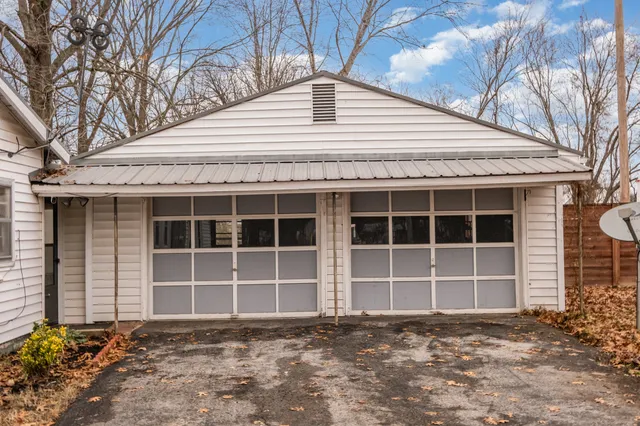 a backyard of house with large trees