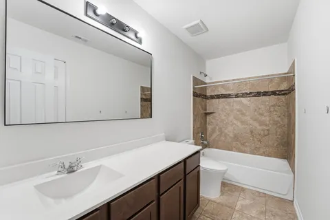 a bathroom with a sink mirror toilet and bathtub