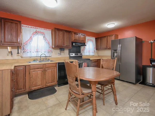 a kitchen with a sink a microwave and refrigerator
