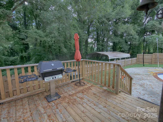 a view of a deck with chairs and wooden fence