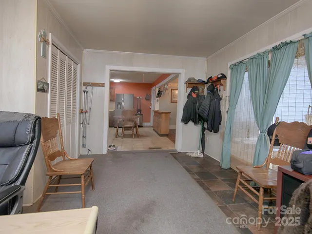 a living room with furniture and a walk in closet
