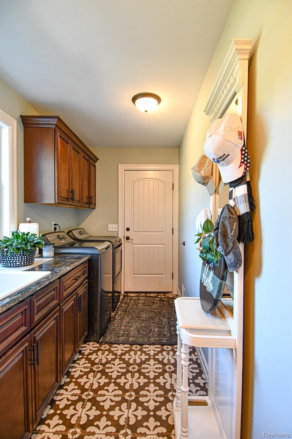 10122 Bennett Lake Road Fenton, MI 48430 - Photo 47 of 56 Laundry Room/Mudroom with sink and granite countertops and classic ceramic tile