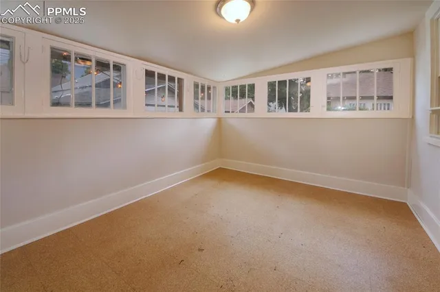 a view of an empty room with a window