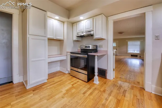 a kitchen with stainless steel appliances granite countertop a refrigerator and a stove