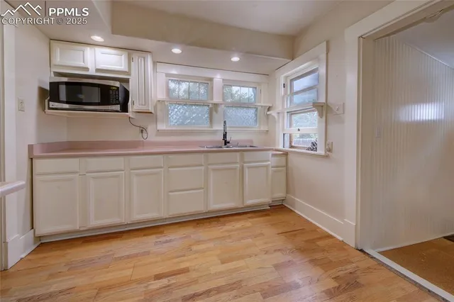 a kitchen with stainless steel appliances granite countertop a sink and a microwave