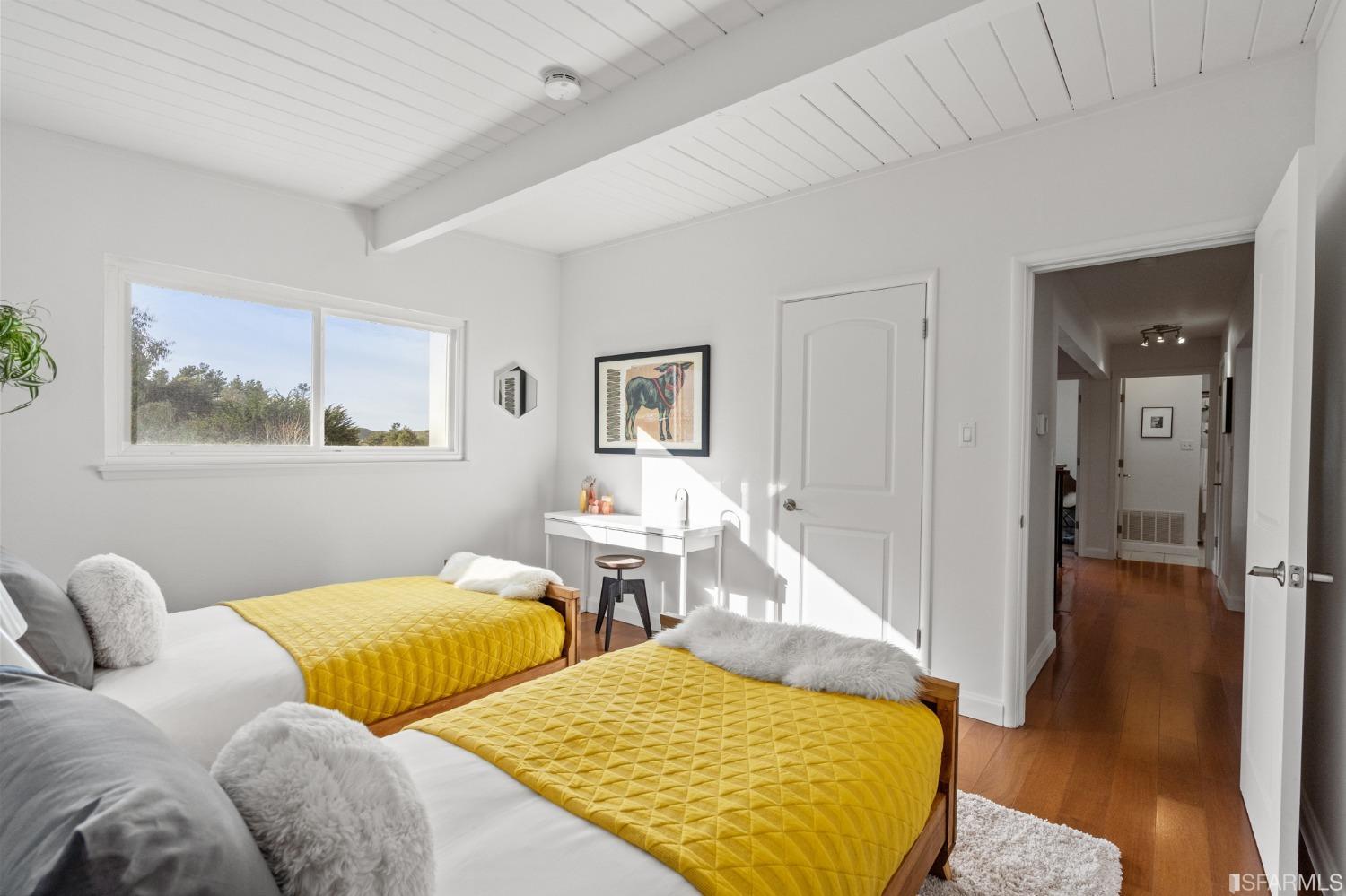 296 Reichling Avenue Pacifica, CA 94044 - Photo 11 of 39 a bedroom with two beds and a table