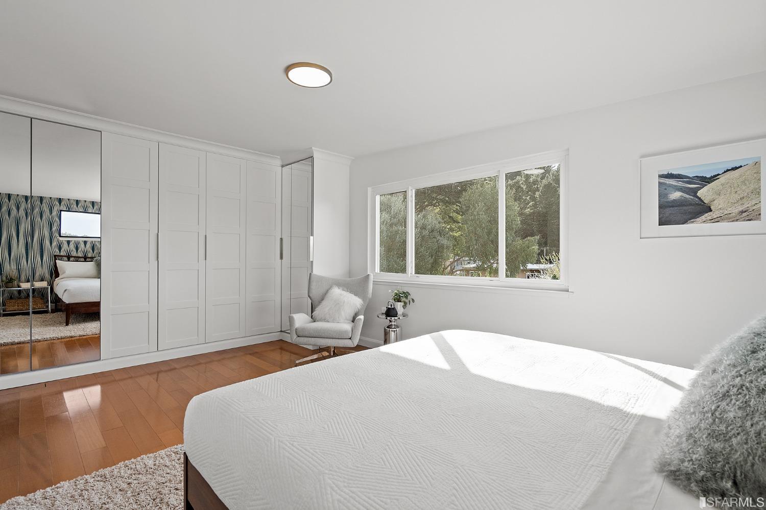 296 Reichling Avenue Pacifica, CA 94044 - Photo 16 of 39 a bedroom with a large bed and a window