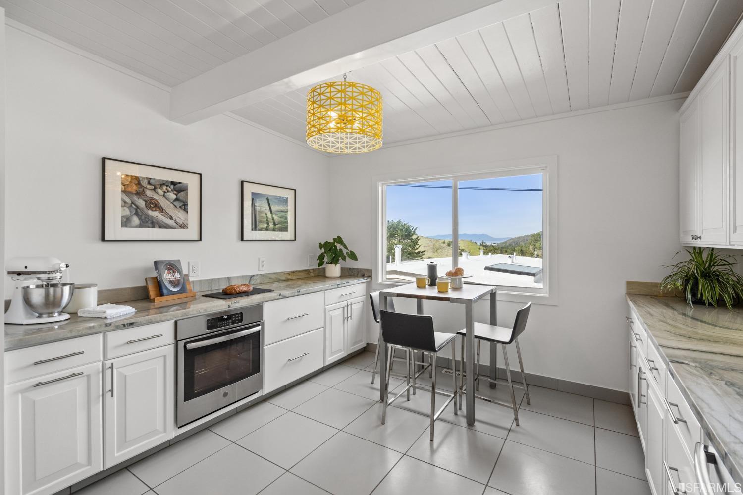 296 Reichling Avenue Pacifica, CA 94044 - Photo 7 of 39 a view of a kitchen with a dining table and chairs