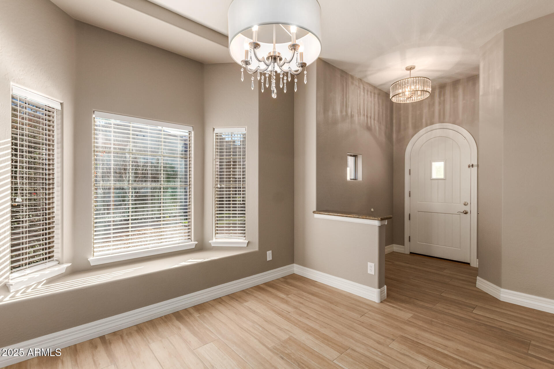16607 North 50th Way Scottsdale, AZ 85254 - Photo 4 of 24 a view of an empty room with wooden floor and a window