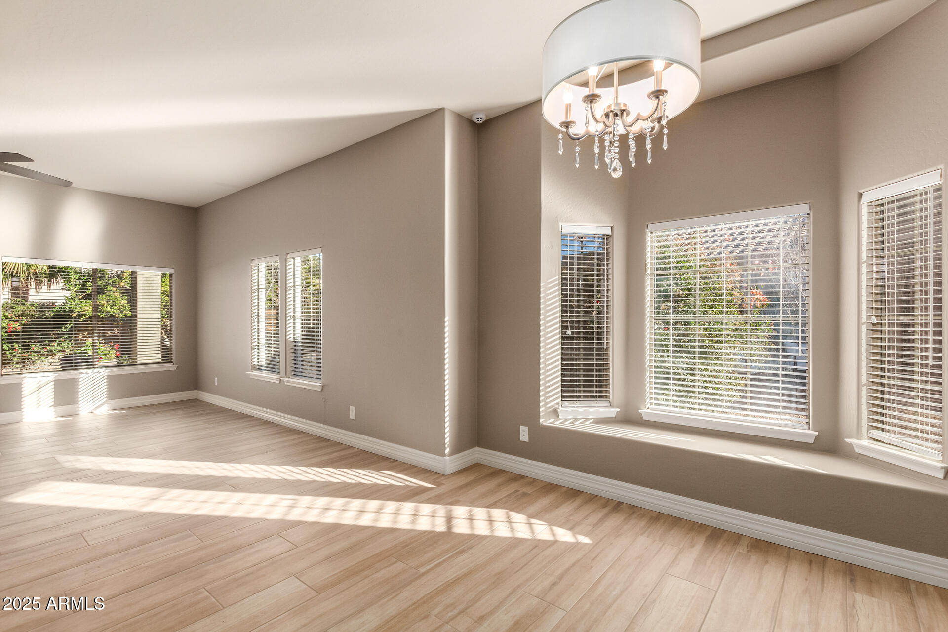 16607 North 50th Way Scottsdale, AZ 85254 - Photo 5 of 24 a view of an empty room with wooden floor and a window