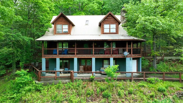 a view of a house with a yard and sitting area