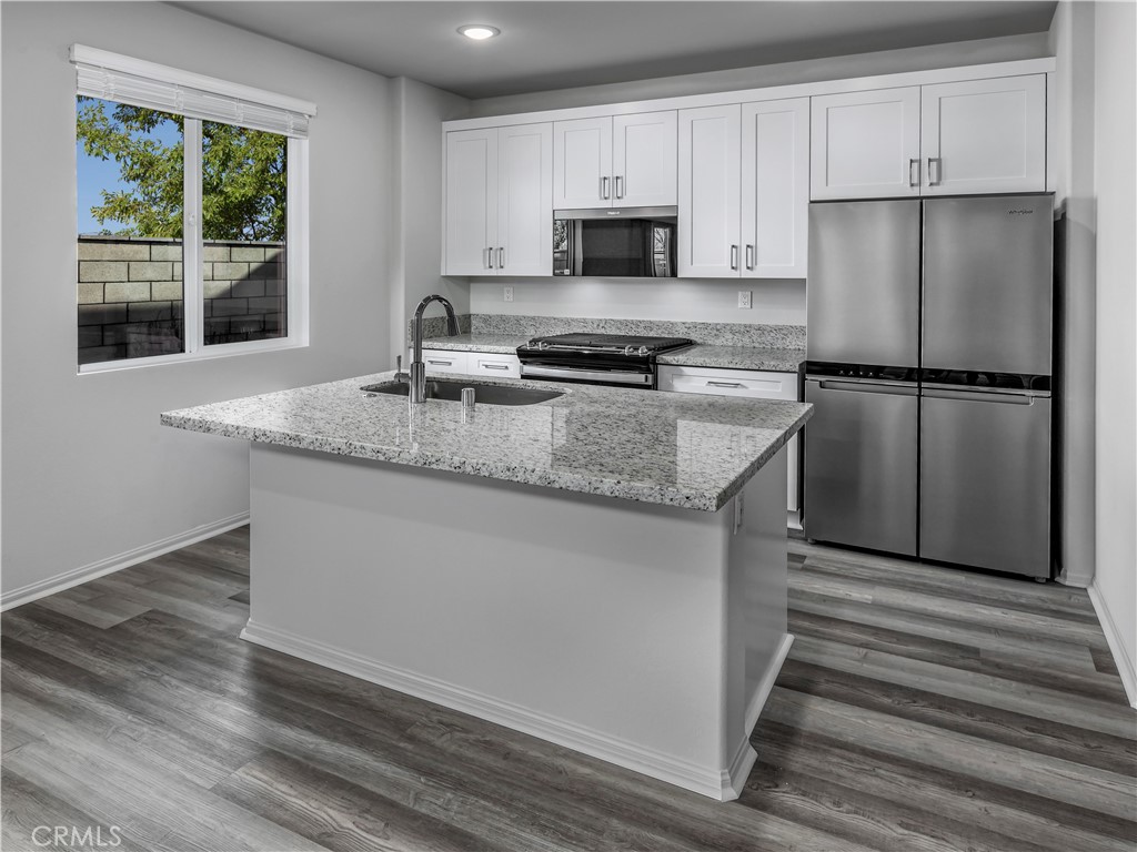 28473 Via Rioja Temecula, CA 92591 - Photo 2 of 7 a kitchen with a refrigerator a stove a microwave a sink and cabinets