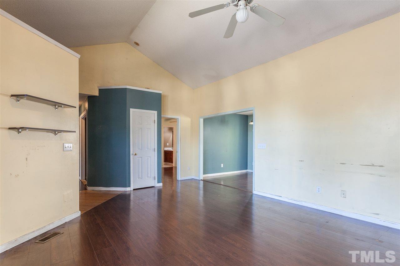 2309 Havering Place Raleigh, NC 27604 - Photo 12 of 23 a view of an empty room with a window and wooden floor