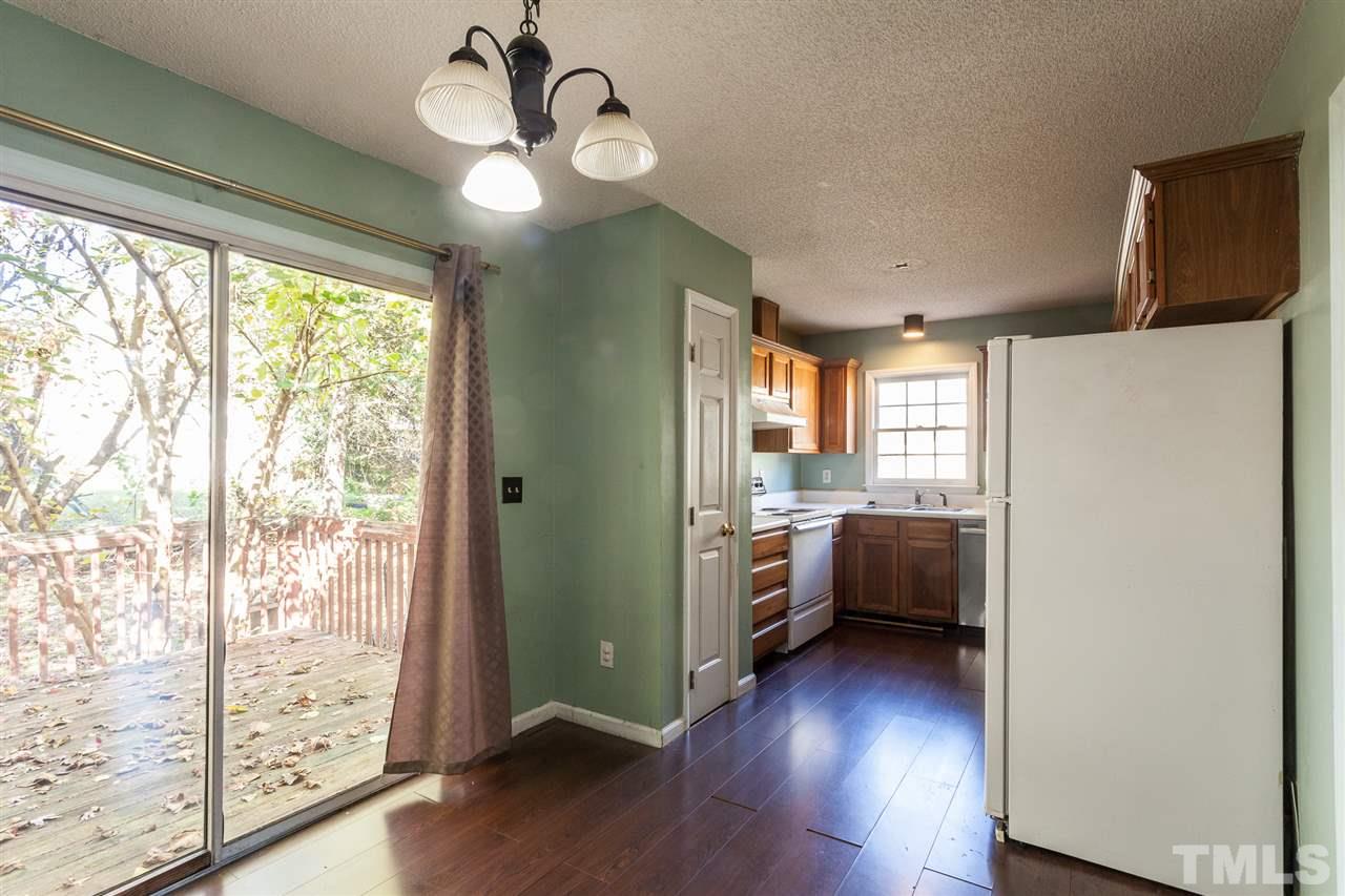 2309 Havering Place Raleigh, NC 27604 - Photo 14 of 23 a view of a big room with wooden floor and windows