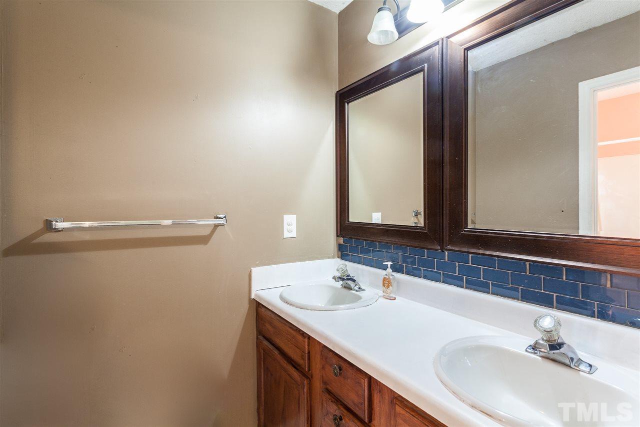 2309 Havering Place Raleigh, NC 27604 - Photo 17 of 23 a bathroom with a sink and a mirror