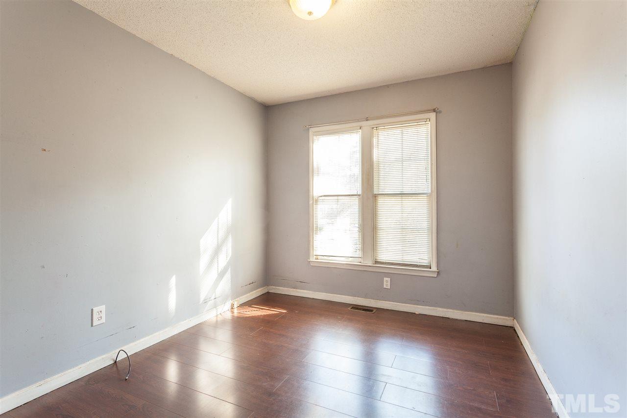2309 Havering Place Raleigh, NC 27604 - Photo 18 of 23 an empty room with wooden floor and windows