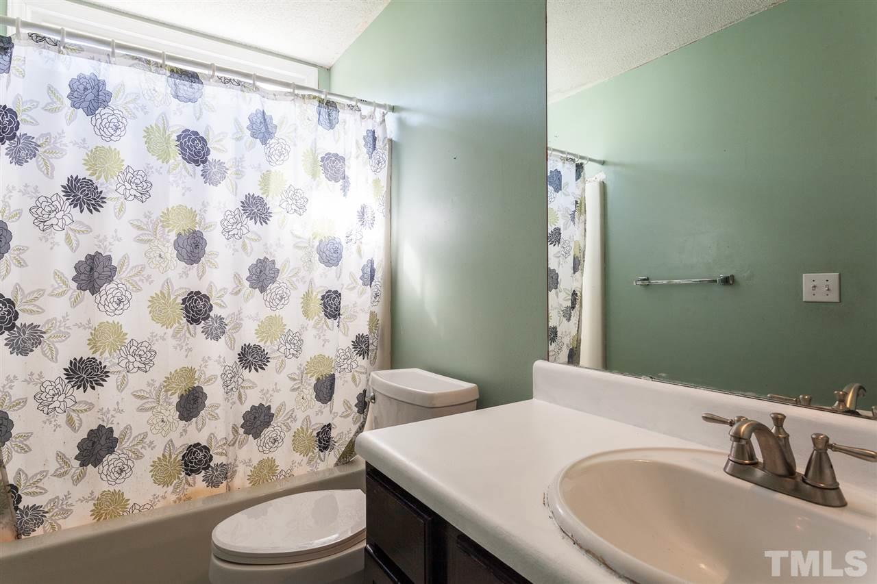 2309 Havering Place Raleigh, NC 27604 - Photo 23 of 23 a bathroom with a sink and a mirror