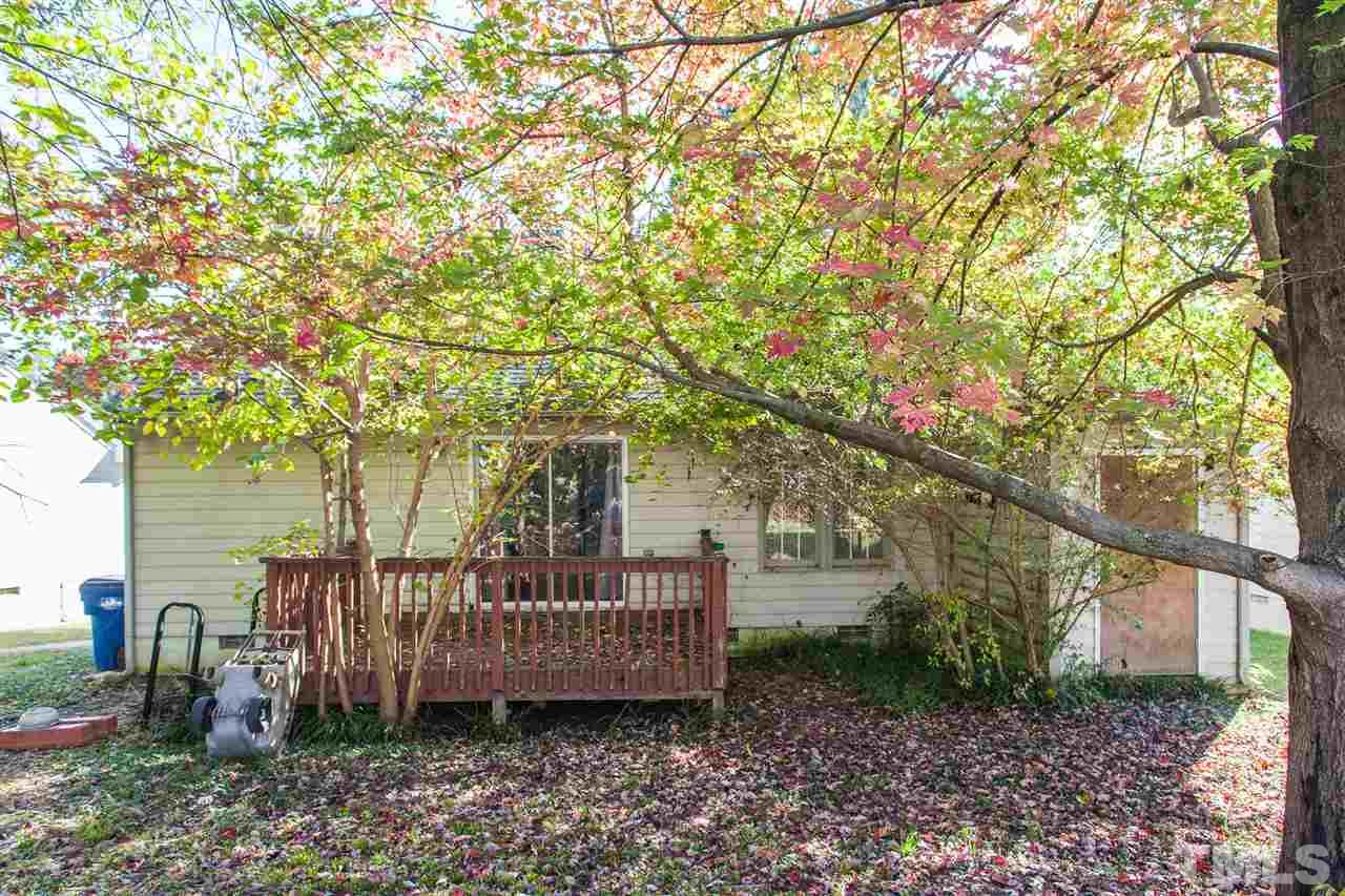 2309 Havering Place Raleigh, NC 27604 - Photo 5 of 23 a view of a deck with a large tree and wooden fence