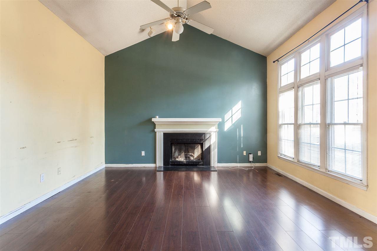 2309 Havering Place Raleigh, NC 27604 - Photo 10 of 23 wooden floor fireplace and windows in an empty room