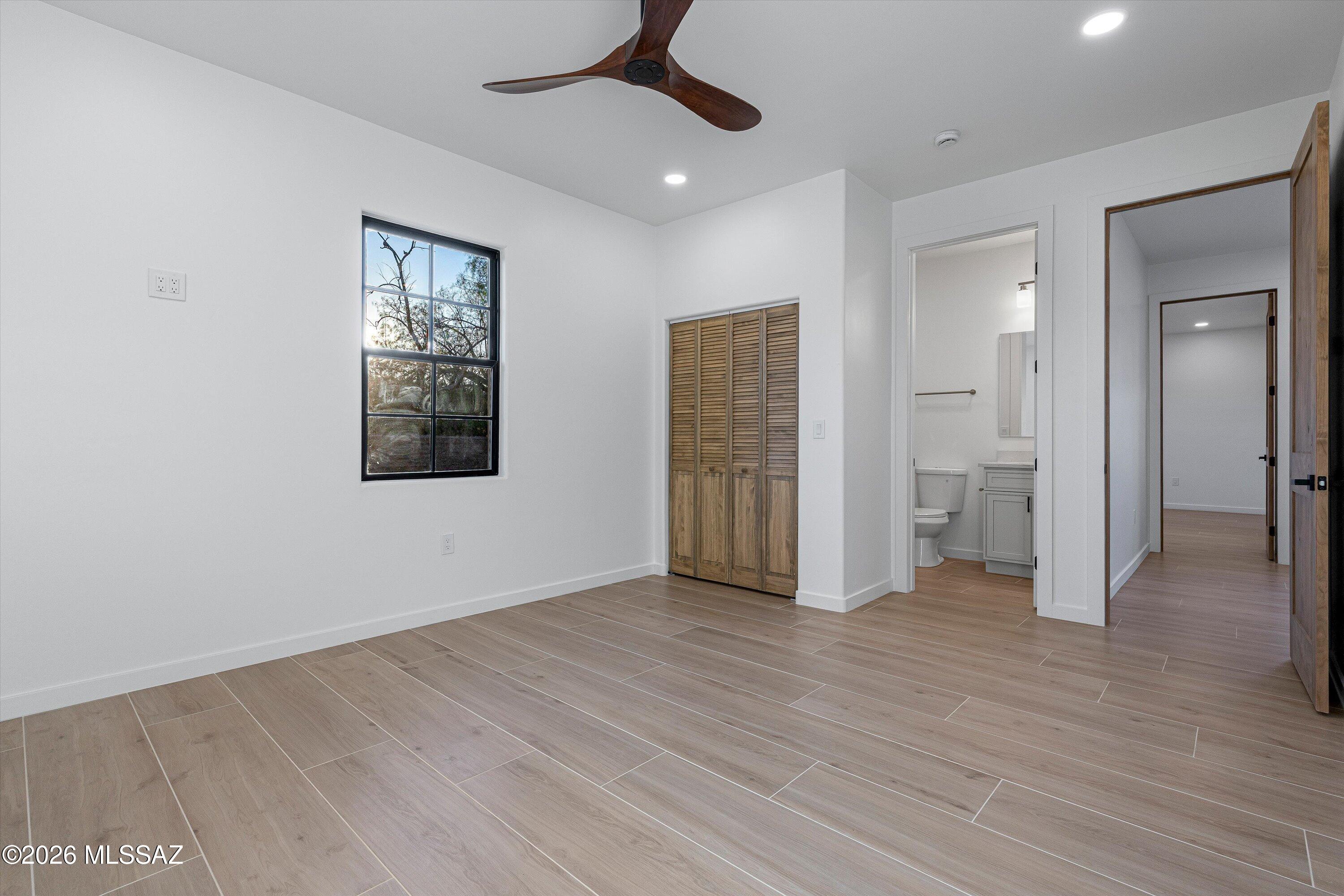 5259 East Fort Lowell Road Tucson, AZ 85712 - Photo 31 of 50 a view of an empty room with wooden floor and a window