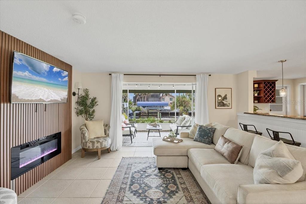 4696 Pompano Street Placida, FL 33946 - Photo 7 of 23 a living room with furniture and a floor to ceiling window