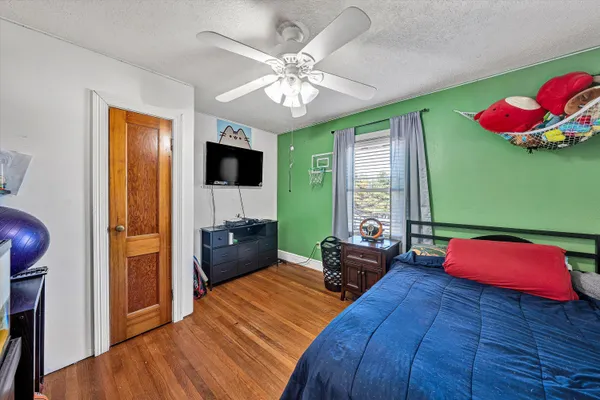 a bedroom with a bed and a chandelier