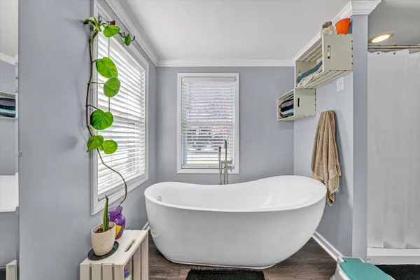 a spacious bathroom with a granite countertop sink a toilet and a mirror