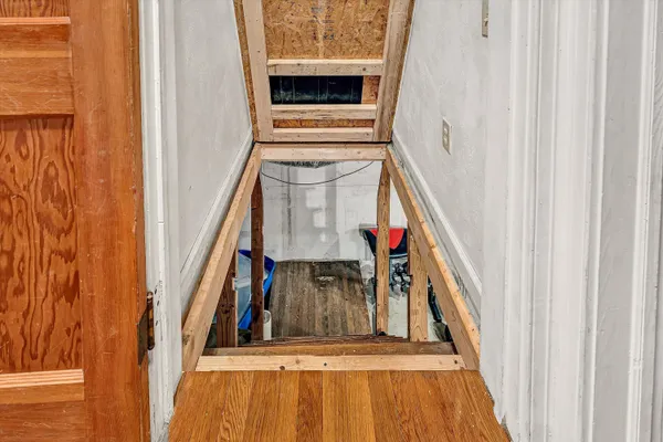 a view of a room with wooden floor and furniture
