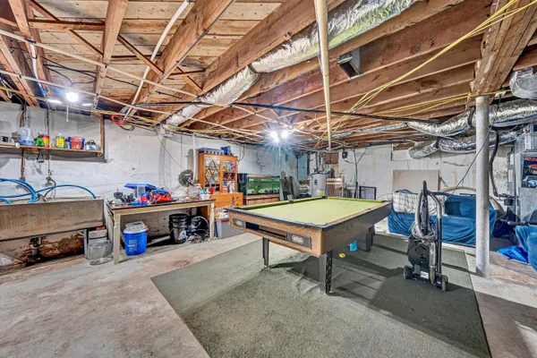 a store room with lots of clutter and furniture