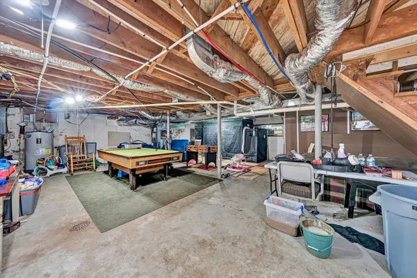 a backyard of a house with fire pit and trees