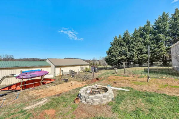 a view of a house with backyard and a tree