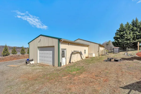 a view of a house with a backyard