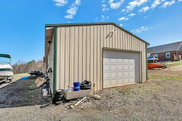 a view of house with garden and tall trees