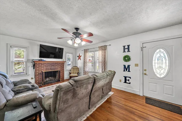 a living room with furniture fireplace and flat screen tv