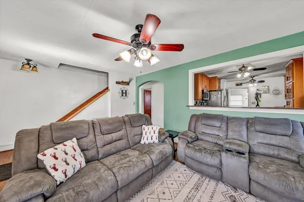 a kitchen with stainless steel appliances a stove top oven a refrigerator and cabinets