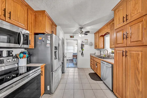 a kitchen with stainless steel appliances a stove a refrigerator and a sink