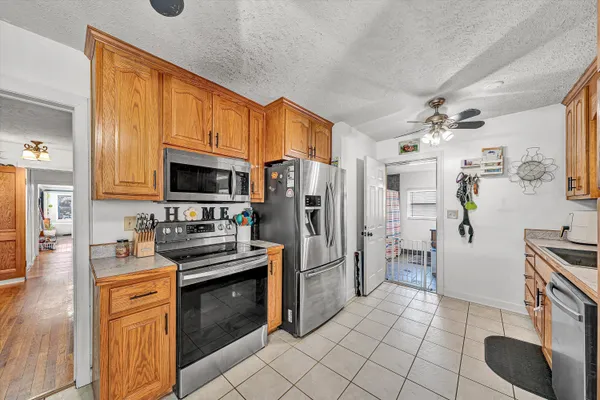 a kitchen with a sink and a stove top oven
