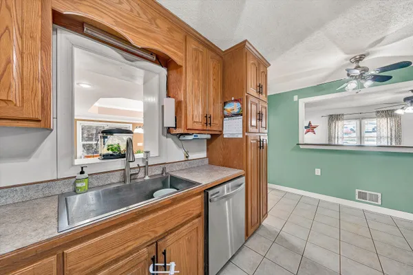 a kitchen with granite countertop stainless steel appliances and a refrigerator