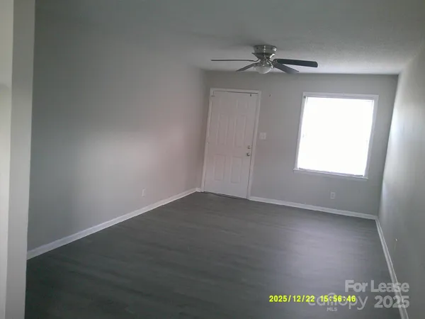 a view of an empty room and a window