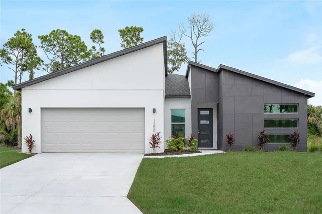 a front view of a house with a yard and garage