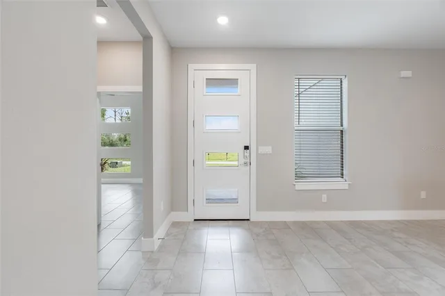an empty room with windows and closet
