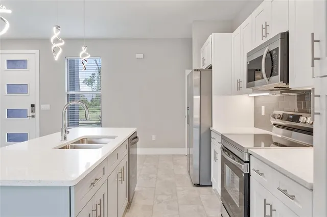 a kitchen with a sink stove and refrigerator