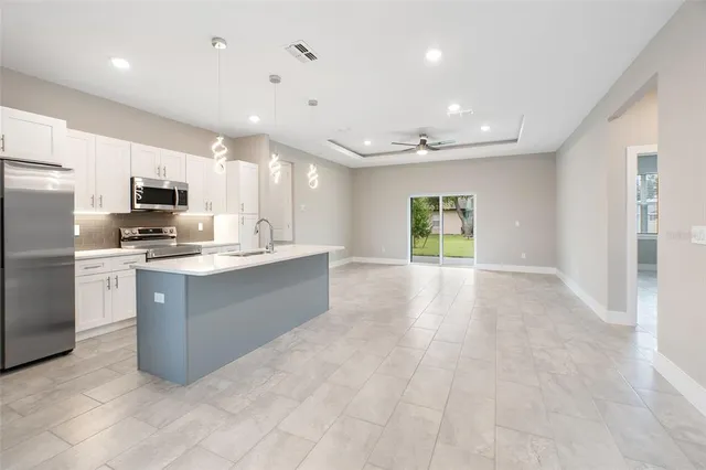 a view of kitchen with stainless steel appliances granite countertop cabinets and a refrigerator
