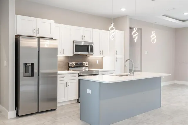 a stove top oven sitting inside of a kitchen