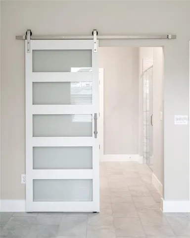 an empty room with closet and a ceiling fan