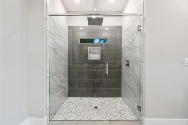 a bathroom with a shower and a window