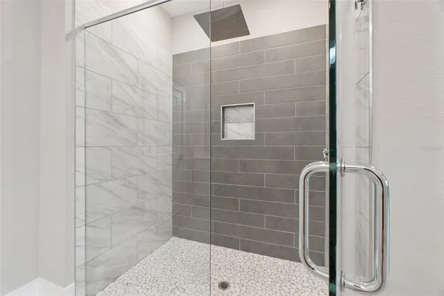 a bathroom with a shower sink and mirror