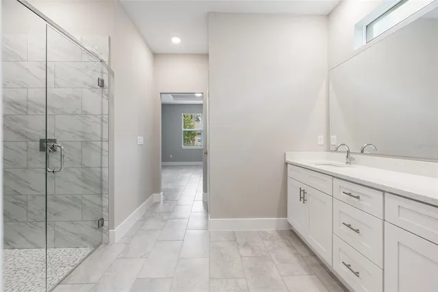 a bathroom with a double vanity sink and mirror